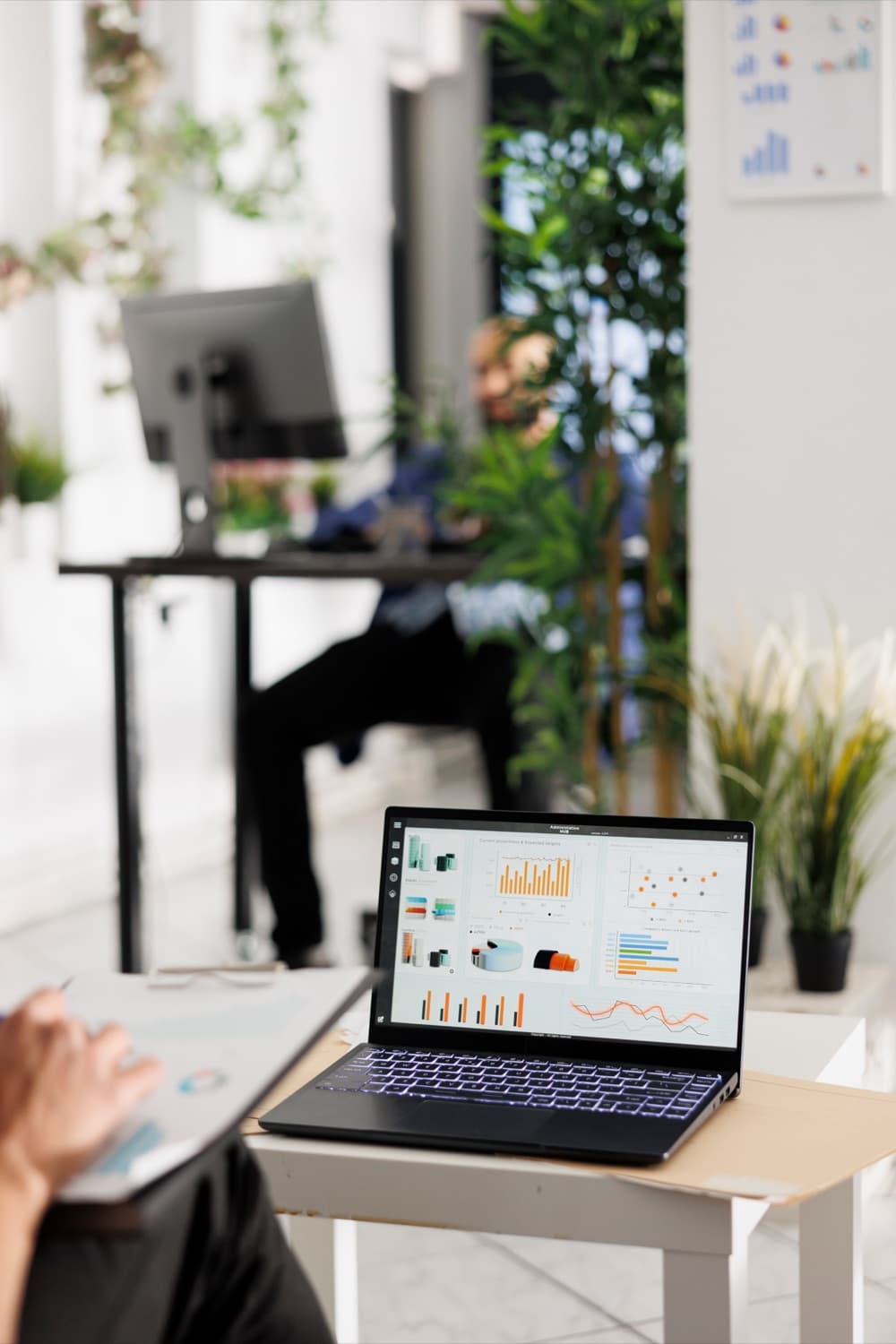 Laptop showing an ad performance dashboard in an office